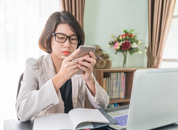 Business person using phone while sitting at table