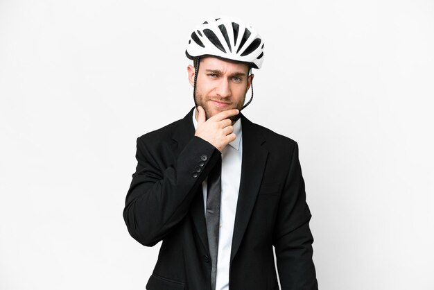 Photo business person with a bike helmet over isolated white background thinking