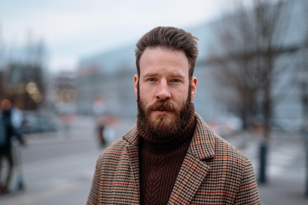 Business portrait of standing man in outdoor looking to camera high quality photo