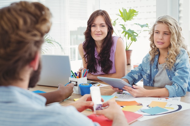 Business professionals discussing in creative office