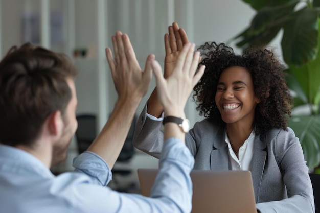 Photo business professionals high five during meeting