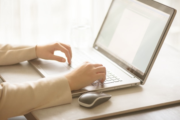 Business, remote work, always connect, online banking, online shopping concept. Freelancing woman using laptop computer for distance job at home. Copy space. Light bokeh concept