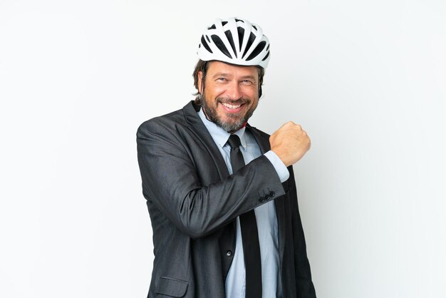 Business senior man with a bike helmet isolated on white background celebrating a victory