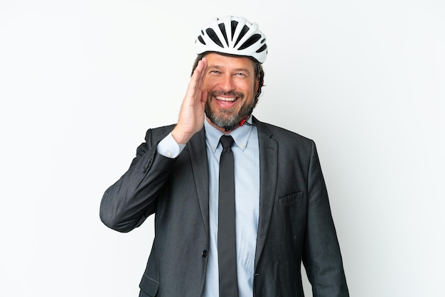 Business senior man with a bike helmet isolated on white background shouting with mouth wide open