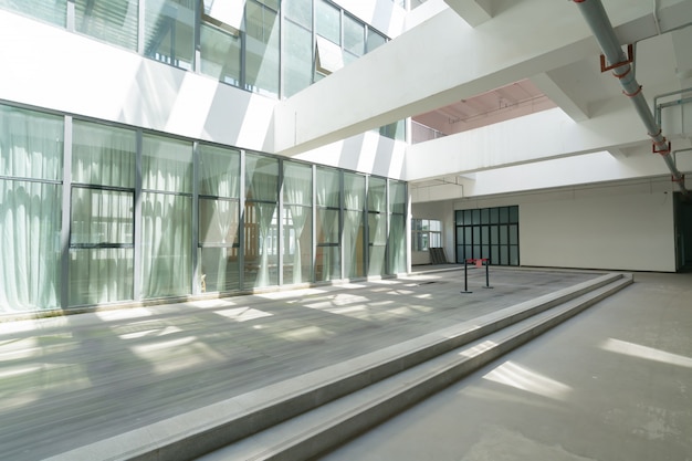 Foto spazio commerciale con vetrate e pavimento in cemento