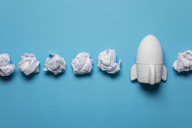 Business startup concept Rocket taking off with crumpled paper trail