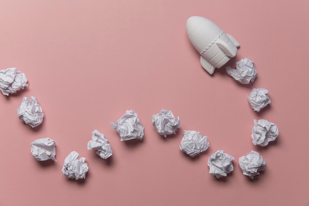 Business startup concept Rocket taking off with crumpled paper trail