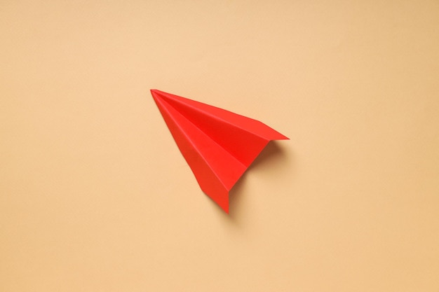 Business startup and sponsorship concept with paper plane on beige background