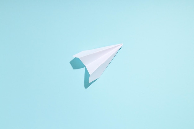 Business startup and sponsorship concept with paper plane on blue background