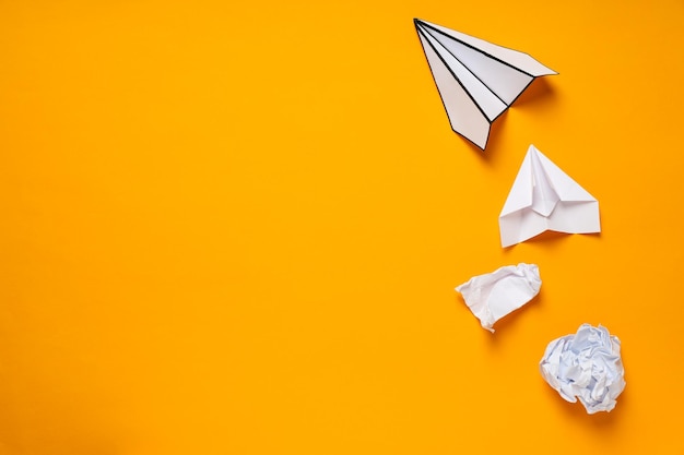 business startup and sponsorship concept with paper planes on yellow background