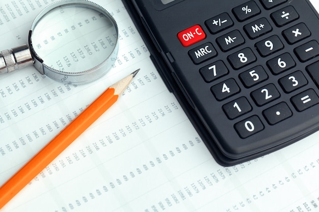 Business still life with calculator on table in office.