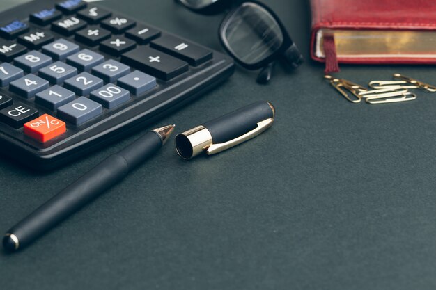 Business still life with calculator on table in office.