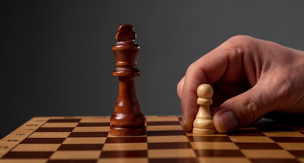 Business strategy concept. Pawn making final last step to make checkmate in chess.