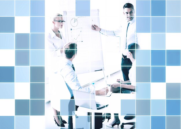 Foto concetto di business, strategia e persone - uomini d'affari con grafico sulla lavagna a fogli mobili alla presentazione in ufficio su sfondo blu griglia quadrata