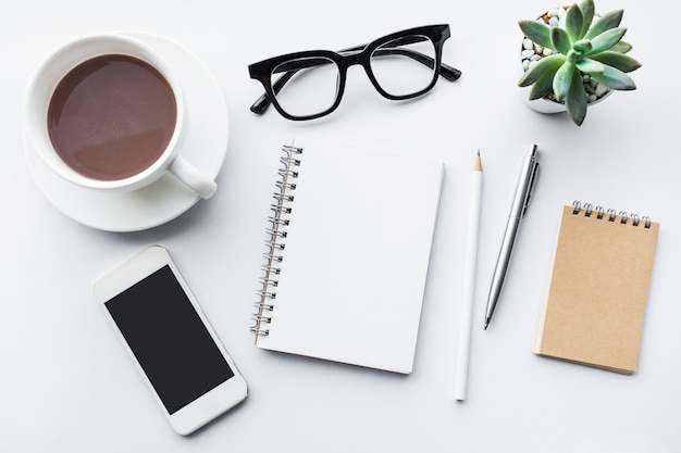 Business table top with office supplies on white background.