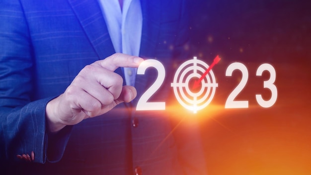 Business target and goal 2023 icon hand pointing holding 2023 virtual screen Start new year 2023 with a goal plan action plan strategy new year business vision