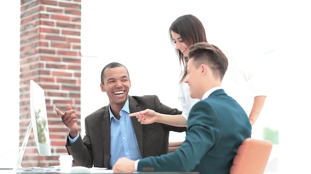 Business team analyzing operational information sitting at their Desk