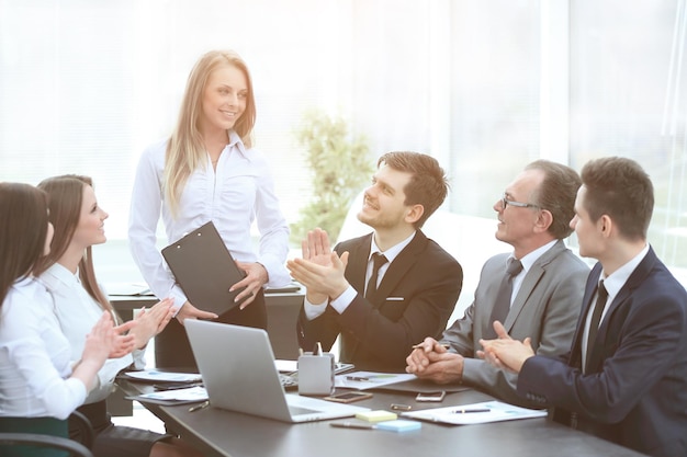 Business team applauding the speaker at the meeting