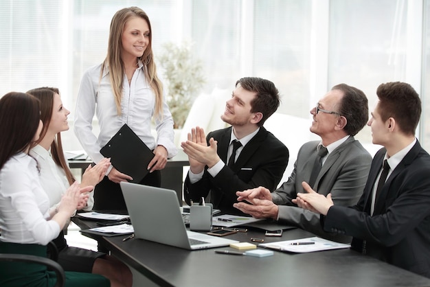 Business team applauding the speaker at the meeting