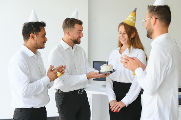 business team celebrating a birthday in the office