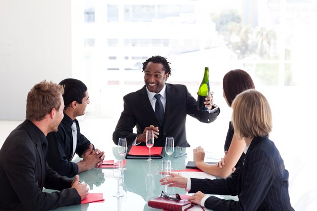 Business team celebrating a success with champagne