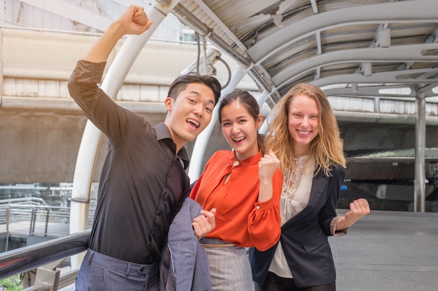 Business team celebrating a triumph with arms up