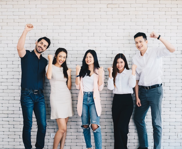 Business team celebrating a triumph with arms up