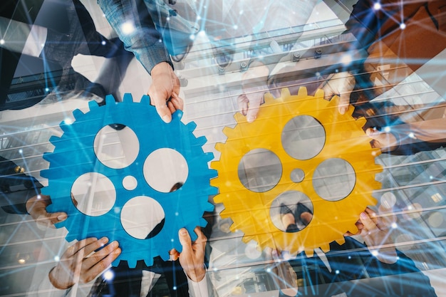 Business team connect pieces of gears like a teamwork and partners