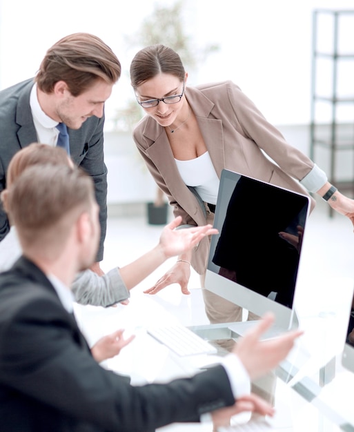 Business team discusses online news in the office