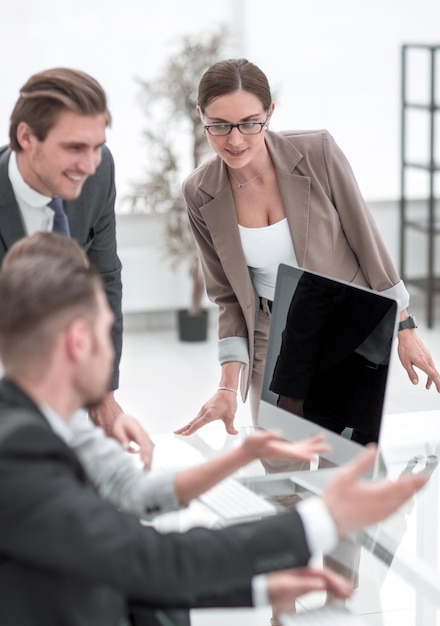 Business team discusses online news in the office