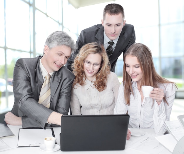 Business team discussing business issues sitting behind a Desk