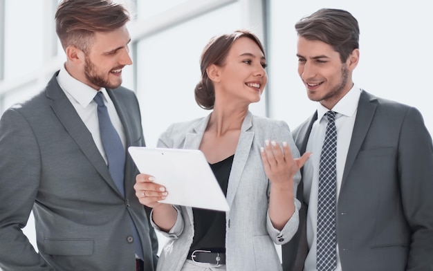 Business team discussing online information on a digital tablet