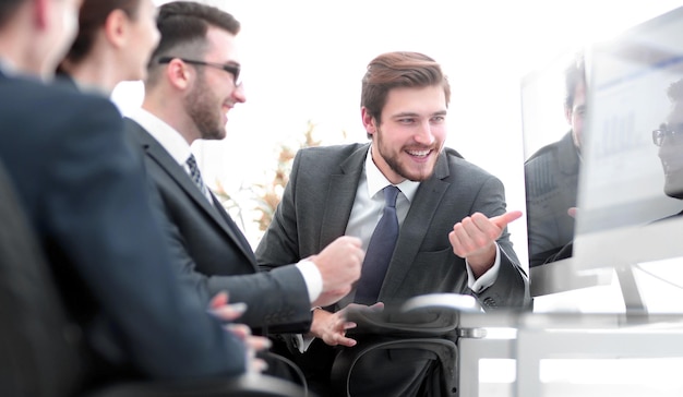 Business team discussing while sitting at their Desk