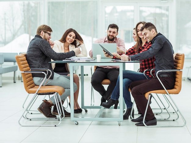 Business team discussing work documents sitting behind a Desk