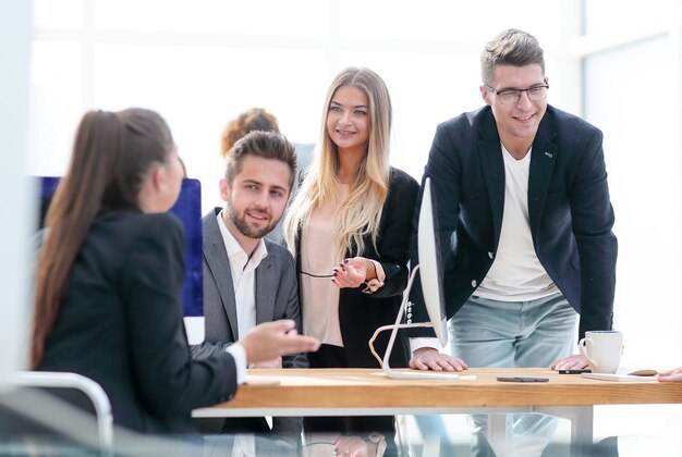 Business team discussing work issues near the desktop