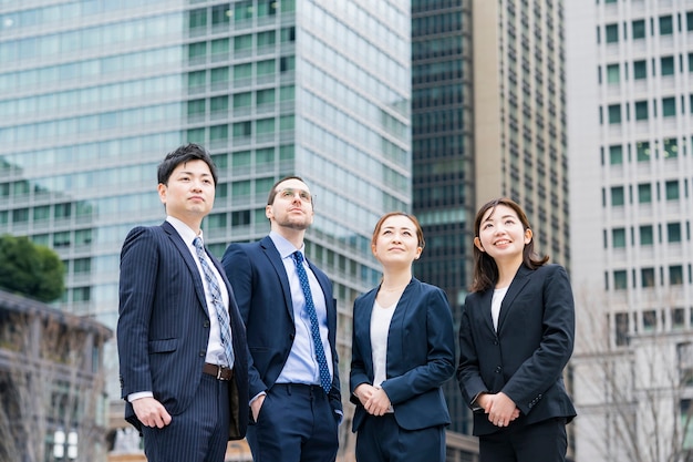 A business team of four men and women in suits