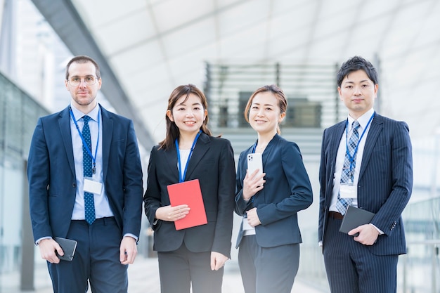 A business team of four men and women in suits