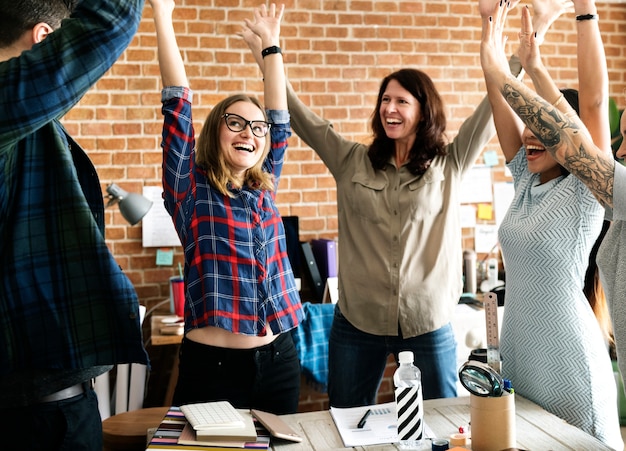 Business team hands raised with successful