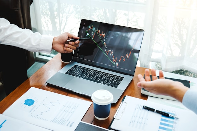 Photo business team investment entrepreneur trading discussing and analysis graph stock market trading