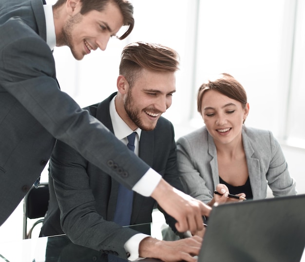 Business team is working on a laptop in the office