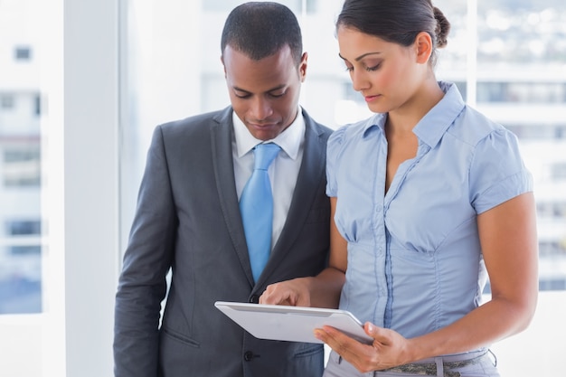 Business team looking at tablet computer