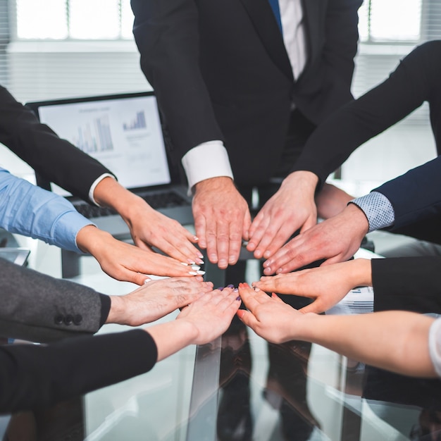 business team making a circle out of their palms