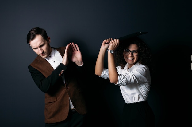 Business team man and woman office workers laugh and quarrel