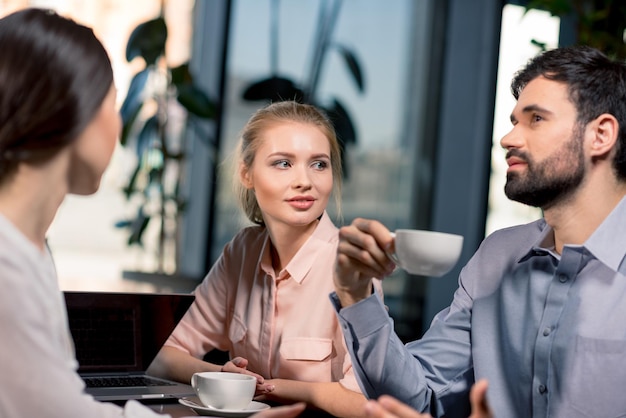 Business team on meeting discussing project in cafe, business lunch concept