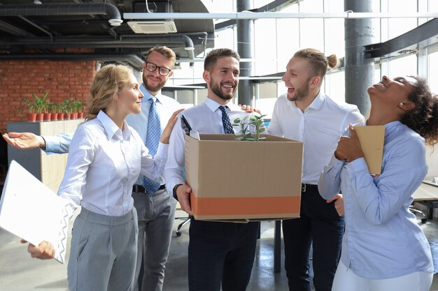 Business team meets a new employee in modern large office.