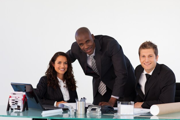 Business team in an office smiling at the camera