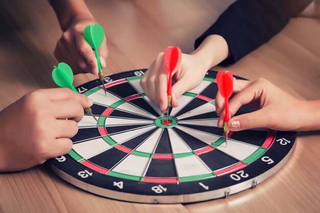 Business team pointing to a darts aiming at the target center business, Targeting the business concept