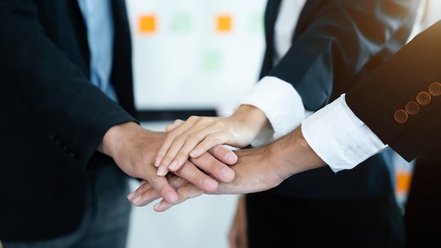 Business team shake hands after agreeing to start a new project\
successfully