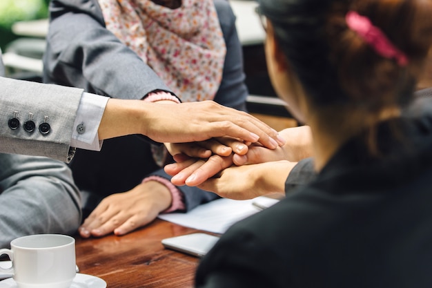 Business team showing unity with their hands together