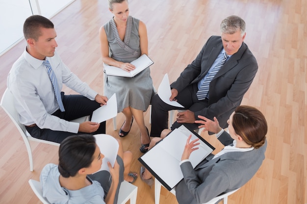 Business team sitting in circle and discussing 